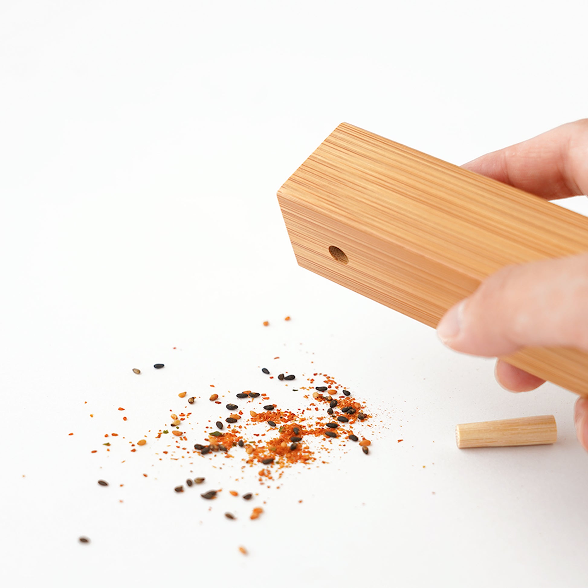 Bamboo spice container pouring mixed spices at SF76
